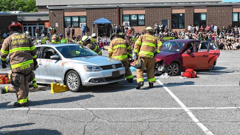 First-responders assist with a simulated two-car vehicle crash Tuesday, June 3 in front of West Milford High School. (Photos by Rich Adamonis)