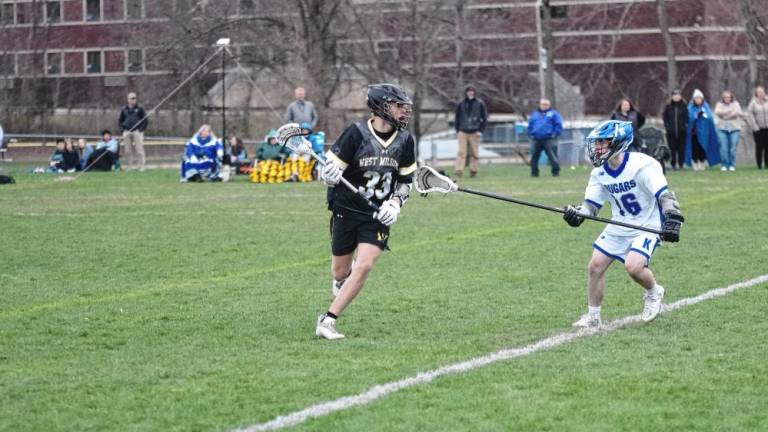West Milford’s Nash Appell carries the ball as Kittatinny’s Greyson Lobb keeps pace in the April 4 game won by the Highlanders, 7-3. Appell scooped up seven ground balls and made two assists. (Photos by George Leroy Hunter)