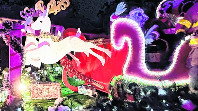 Santa Claus waves from his sleigh on a visit to West Milford.