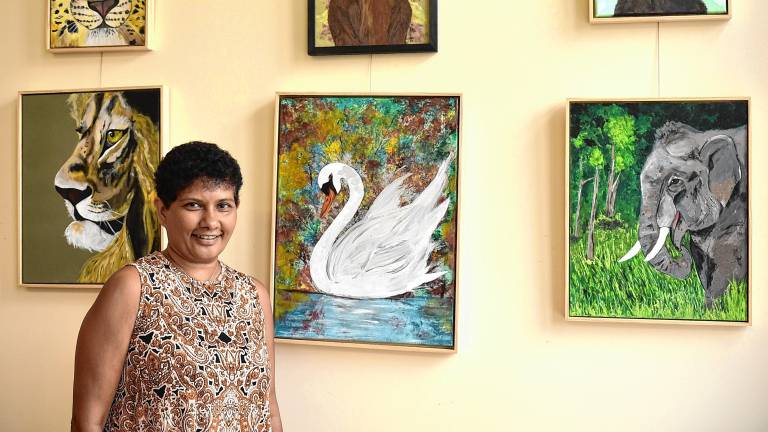 Sue Siva with her paintings on display at the West Milford Township Library. (Photos by Rich Adamonis)