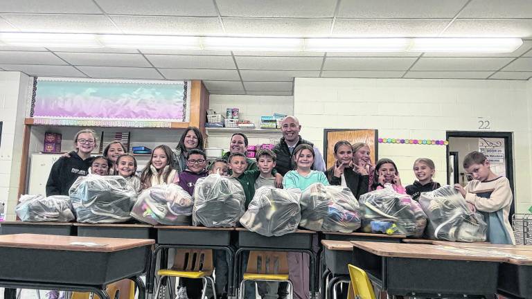 Kids club collects 113 pairs of shoes