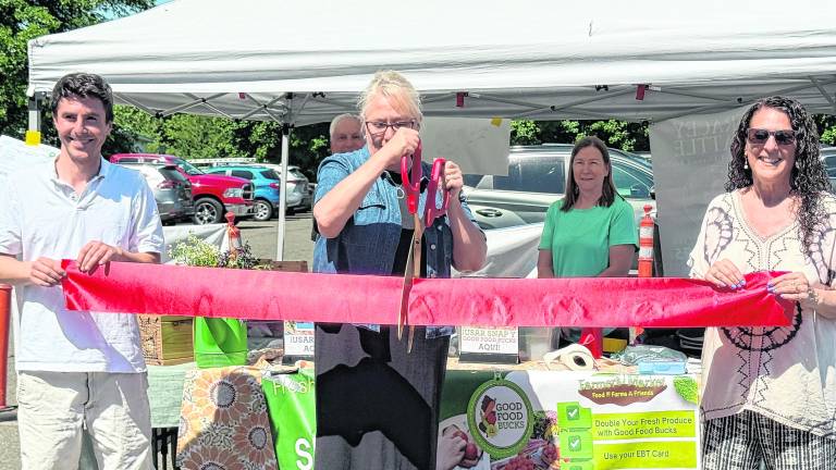 West Milford Mayor Michele Dale cuts the ribbon to open the Farmers' Market season.
