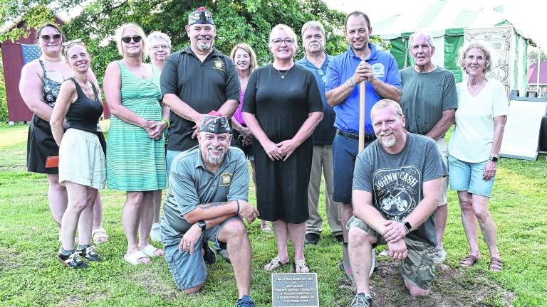 Attendees pose in front of the America250 Time Capsule plot, which will be reopened in 2076.