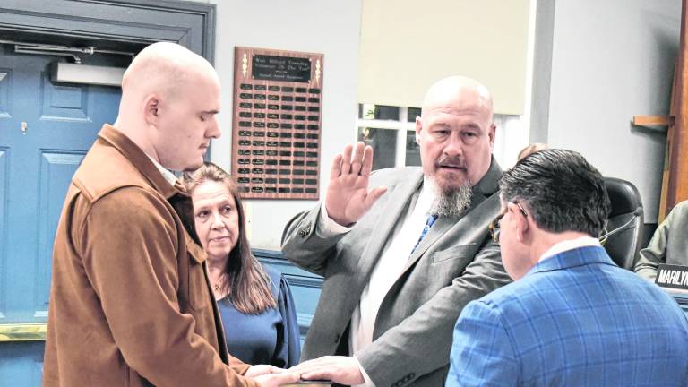 Senator Anthony Bucco (LD-25) swears in Councilman Kevin Goodsir to his third term on the West Milford Township Council as his wife and son look on.