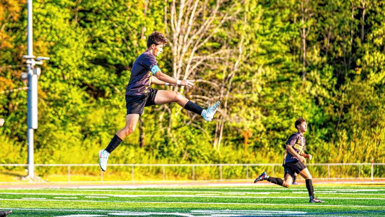 Senior Nick Bognar kicks his ball midair. (Photos by TJ Nolan)