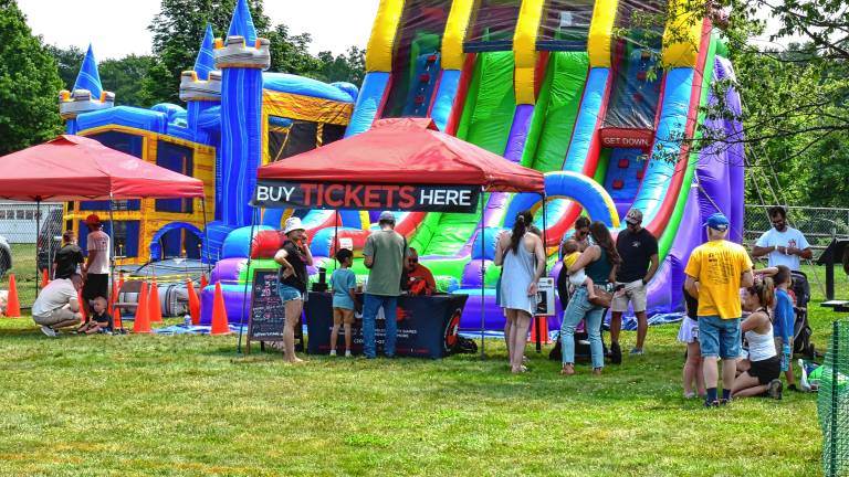 MF1 Children play on an obstacle course with slides and a bouncy castle. (Photos by Fred Ashplant)
