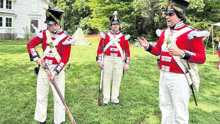 Kyle Parker, John Van Vliet and Jesse Gerber dress as British soldiers.