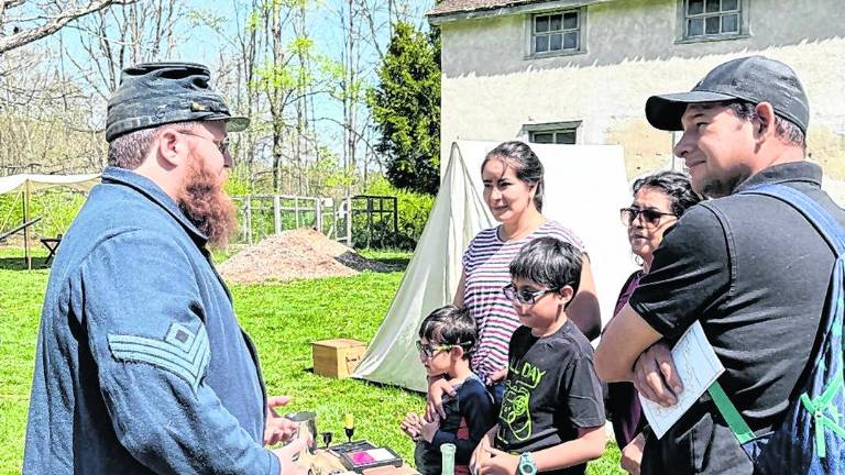 A family gets a look at a Civil War era firearm.