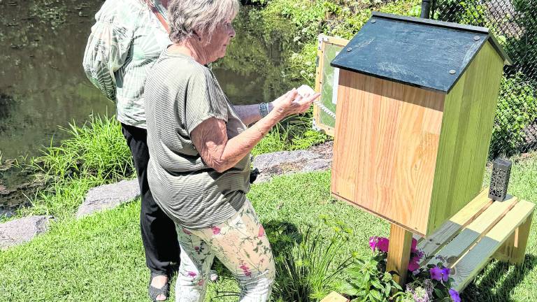 Karen Thompson shows the wind phone to West Milford Mayor Michele Dale.