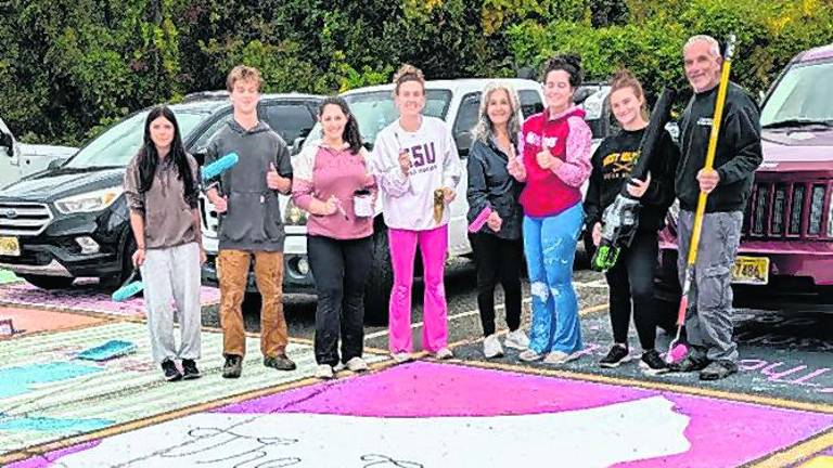 About 40 West Milford High School seniors with help of several parents do the annual ritual of painting assigned parking spaces with bright colors, fun designs and personal messages on Sunday, Oct. 4.