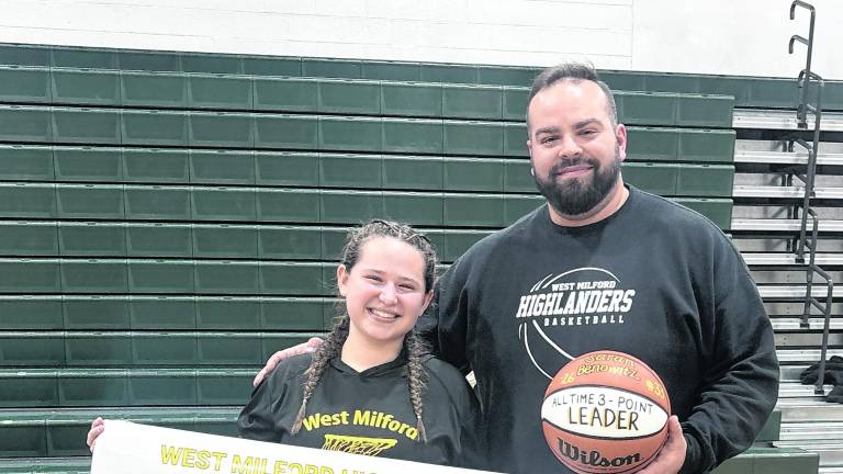 High school senior and varsity basketball captain Sarah Benowitz set a new school record during Wednesday night’s game, celebrated alongside her coach.
