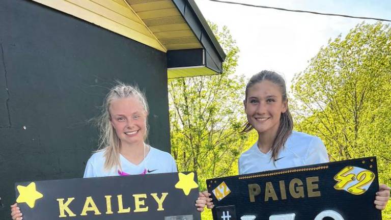 Kailey Maskerines, left, and Paige Fava celebrate milestones at the Passaic County Tournament girls lacrosse semifinal game Wednesday, May 8. (Photos provided)