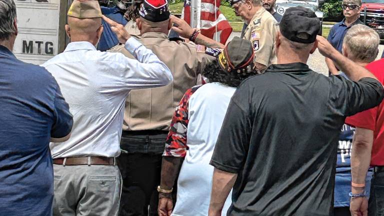 Members of West Milford Veterans of Foreign Wars (VFW) Post 7198 salute as flags are raised Sunday, Aug. 17 to commemorate the post’s new home in the former Upper Greenwood Lake Volunteer Ambulance Corps building, 814 Warwick Turnpike, Hewitt. (Photos by Fred Ashplant)