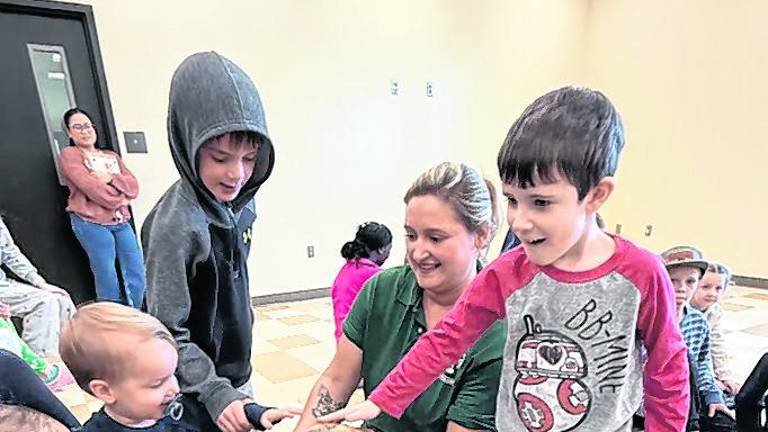 Children feel a turtle.