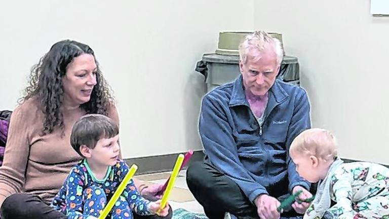 Children discover the beat as the adults look on.