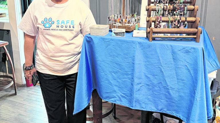 Nancy O’Tool from S.A.F.E. House animal rescue and sanctuary offers jewelry she makes for sale as part of the fundraiser.